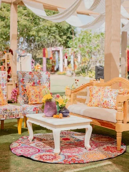 A fun, printed armchair and floor cushion add a pop of color and pattern to this lounge corner at the 'Rajasthani Folklore' Mehendi.