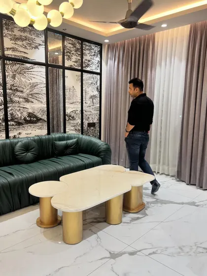 Another angle of the green leather sofa and custom coffee table, showing how the pieces work together in the space.