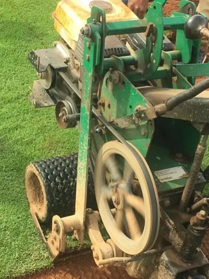 A specialized machine used to harvest the grass from my farm, ensuring each roll is cut to a uniform thickness.