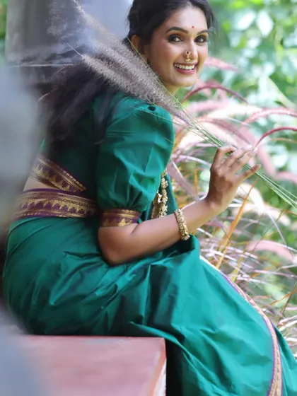 A happy, candid shot showing how natural makeup allows for genuine expression. Her skin is glowing, and her smile is radiant.