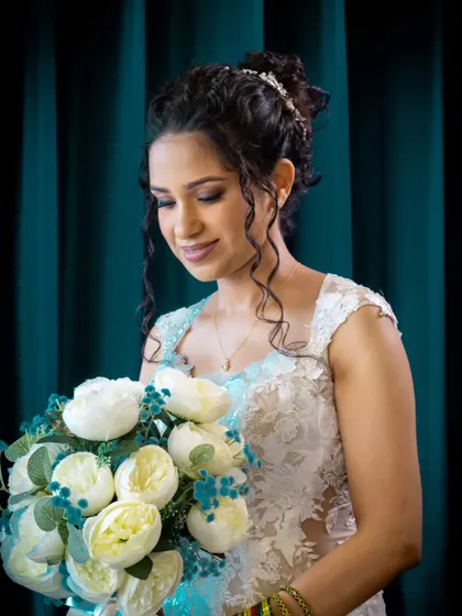 Another angle of this stunning bridal portrait. The lighting highlights the intricate details of her hair and the soft glow of her skin.