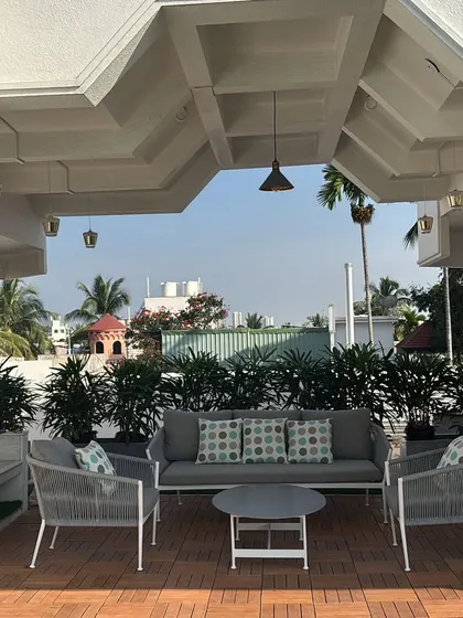 A spacious terrace designed for outdoor living in Basaveshwara Nagar. The combination of WPC deck tiles and comfortable, modern outdoor furniture creates an inviting area for hosting guests or enjoying a quiet morning coffee.
