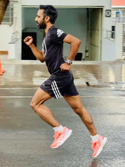 A picture of me demonstrating proper running posture. My focus is on a high cadence, forward lean, and relaxed upper body to maximize efficiency.