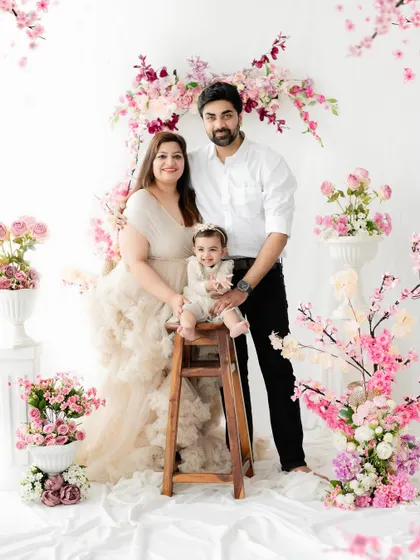 A beautiful family portrait in our floral studio setup. The soft pink cherry blossoms create a dreamy and romantic background for this family of three.