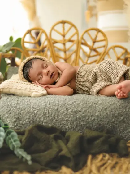 It's a boy! This little man looks so peaceful sleeping on this tiny bed. I love using natural props like this rattan bed for a gentle, organic feel.