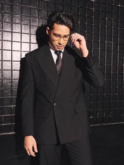 For Siddhant Chaturvedi, I commissioned this custom double-breasted suit. The wide lapels and relaxed fit give a modern twist to a classic black suit, perfect for a formal event.
