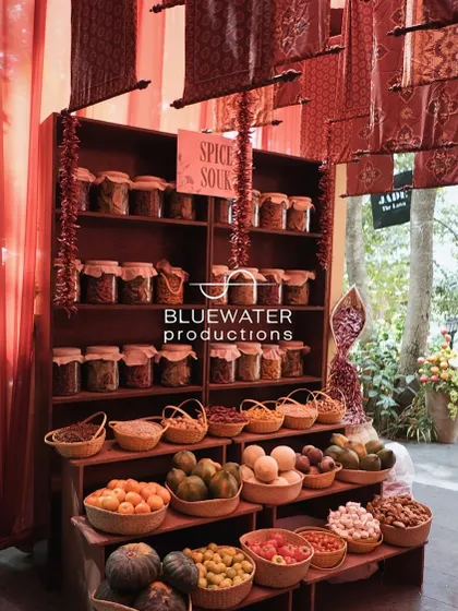 The 'Spice Souk' stall, with shelves of spices and baskets of fresh produce.