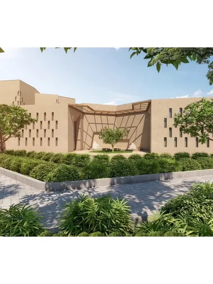 The entrance to one of the buildings in the Qism Al Tahfeez center. The design uses earthy materials and perforated screens (jaalis) to create a building that is both modern and deeply rooted in its cultural context.