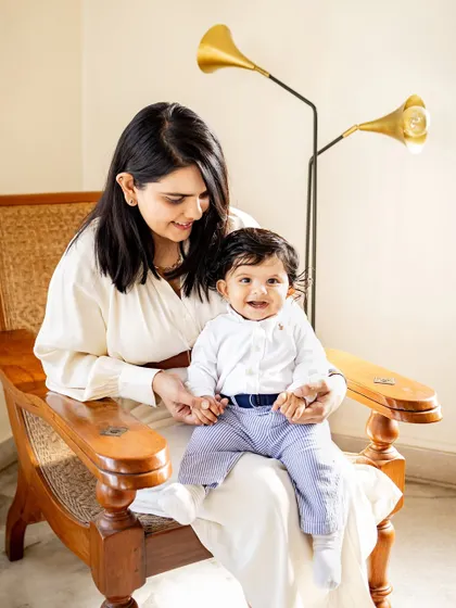 Using the beautiful golden light streaming through the window for a mother and baby portrait. Your home provides the perfect, meaningful backdrop for photos.