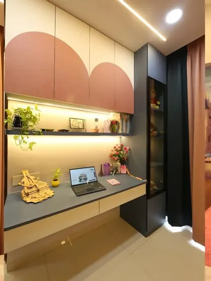 The study area in the princess bedroom is both practical and pretty, with scalloped overhead cabinets and a glass display for treasures.