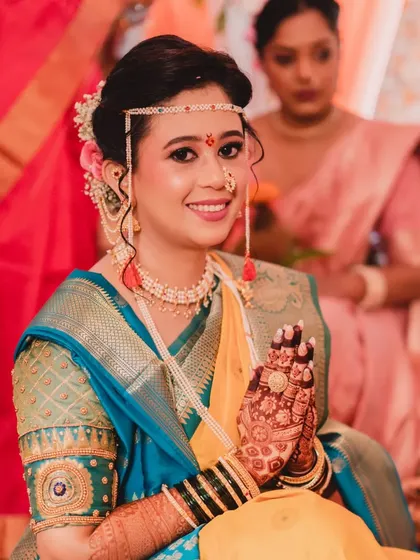 A beautiful portrait of the bride, her hands joined in 'namaste'. The intricate details of her henna and the flawless makeup are on full display.