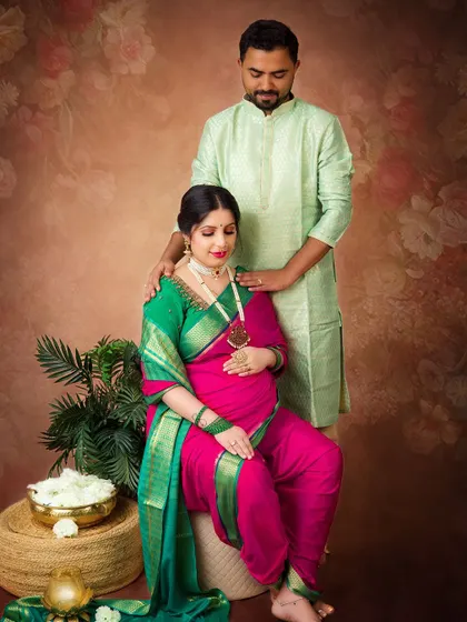 A lovely couple's portrait that captures their shared happiness. The coordinated traditional outfits and the soft, painterly background create a beautiful, harmonious image.
