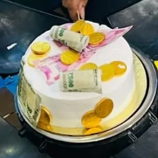 A fun and unique money-themed cake. This design is decorated with edible printed currency notes and gold coins, making it a great cake for celebrating success or a milestone achievement.
