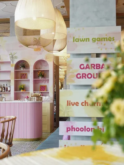 Playful signage and a lively bar setup for the Haldi event, ensuring guests knew where to find the fun, from lawn games to live food counters.