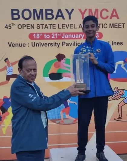 My young athlete Devaj Parekh receiving his Individual Championship trophy in the Boys U/12 category at the 45th YMCA Open State Level meet.