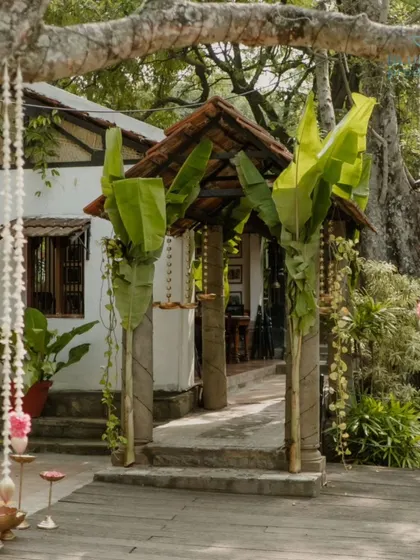 A simple and beautiful entrance at The Tamarind Tree, where traditional banana leaf pillars frame the doorway to the wedding ceremony.