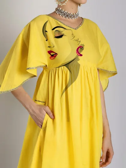 A closer look at the artwork on the yellow kurti. The design is strategically placed to create a unique and artistic statement, making it more than just a piece of clothing.