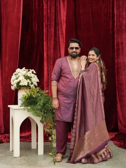 A full-length view of the coordinated anniversary outfits. Styling couples is about creating a visual connection between their looks, and this was a perfect example.