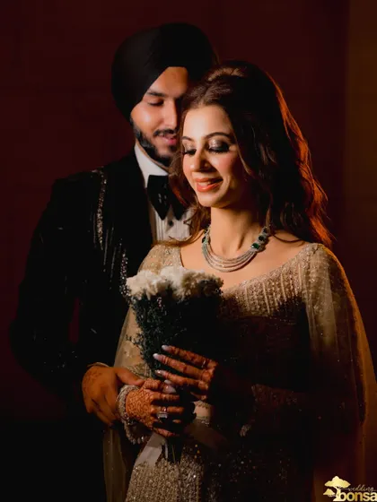 An intimate, low-light portrait of the couple during their engagement, creating a moody and romantic feel.