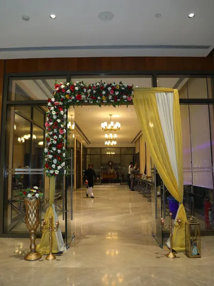 An interior floral archway guiding guests into the main celebration area.