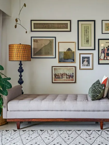 A tufted daybed placed against a gallery wall creates a stylish and functional focal point. It's a versatile piece that works beautifully in living rooms or home offices.