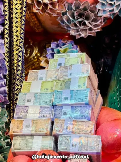 A display of the actual currency bundles used in creating the pandal artwork, showcasing the scale and authenticity of the project. This was a unique decoration that required immense planning and trust.