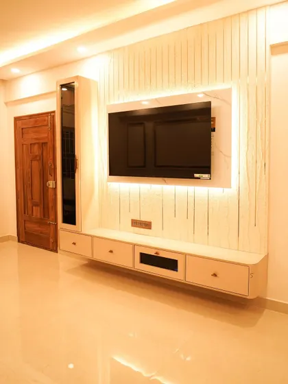 A full view of the elegant TV unit, featuring a floating console, vertical fluting, and a tall display cabinet with a smoked glass door.