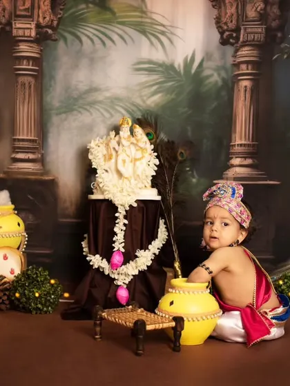A wide shot of our elaborate Janmashtami set, featuring a little Krishna exploring among peacocks and floral decorations.
