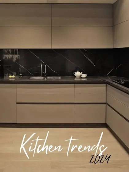 A bold and dramatic kitchen concept from our 2024 trends portfolio. This design pairs neutral-toned cabinets with a striking black marble backsplash and countertop, creating a powerful visual statement. The handleless design keeps the focus on the luxurious materials.