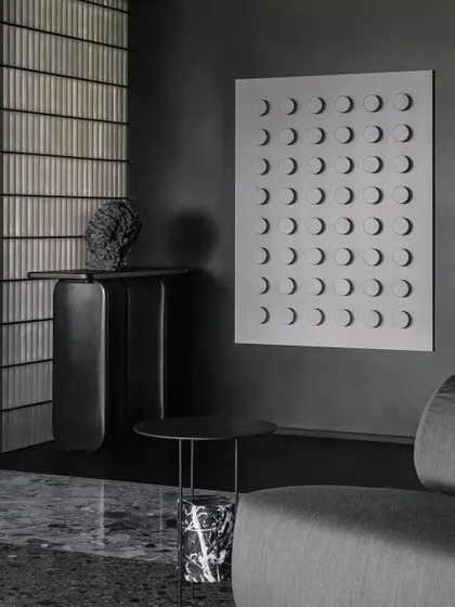 A custom geometric wall installation sits beside the entrance console in the Vaulted Haus. This piece of wall art adds another layer of texture and form to the monochromatic and minimalist entrance experience.
