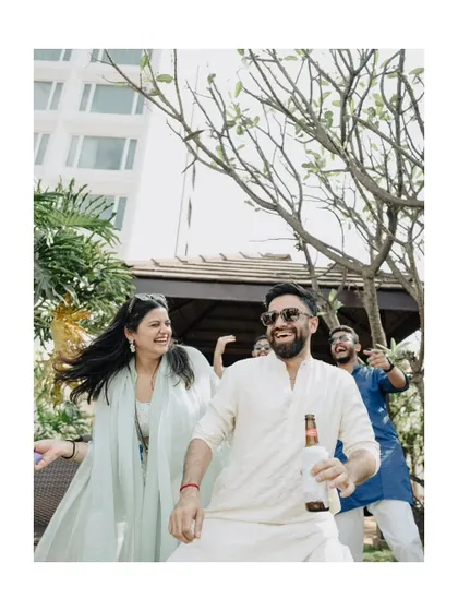 A candid shot of guests enjoying the relaxed and fun atmosphere of a pre-wedding party.