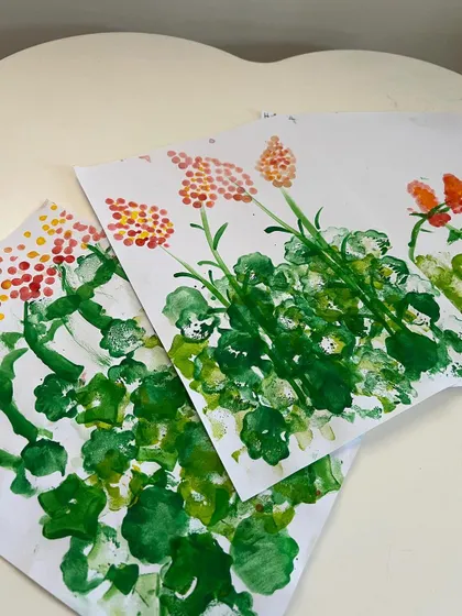 The finished sponge paintings. After creating the green foliage, the kids used cotton buds to dot in colorful flowers.