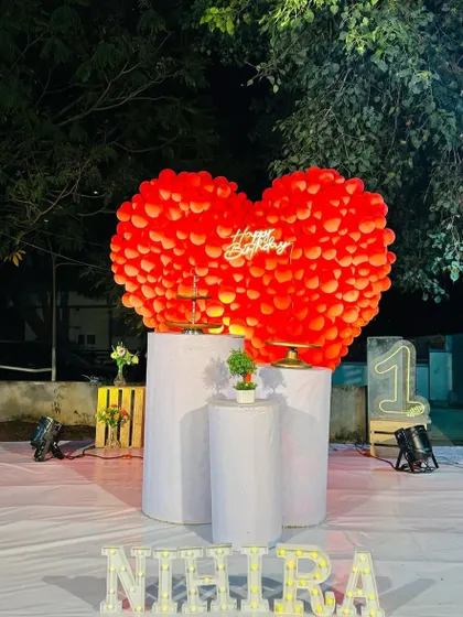 The same red heart decoration in a daytime outdoor setting, showing its impressive scale and vibrant color.