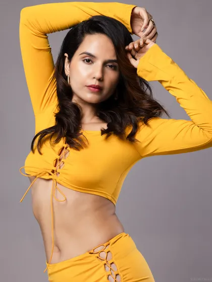 A close-up beauty shot from the yellow outfit series, with a soft and engaging expression.