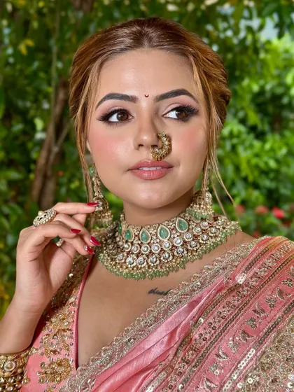 A detailed shot of the eye makeup and traditional nath. The look is effortless and perfect for the bride who values both culture and simplicity.