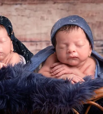 The most adorable twin munchkins. Here they are posed together, showing their connection and individual personalities even at this tiny age.