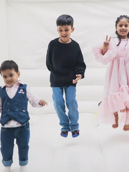 Kids jumping for joy inside our spacious white bouncy castle. The high walls and soft floor ensure a safe environment for energetic play.