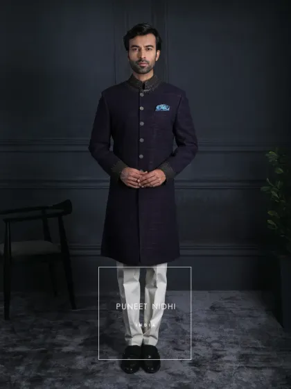 Elegance is eternal. This handloom silk achkan in dark wine celebrates the artistry of Indian hands, with zari embroidery like antique gold treasures and buttons that echo regality.