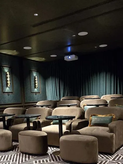 A duplicate of 84, this image showcases the room with the lights dimmed, ready for a private screening.