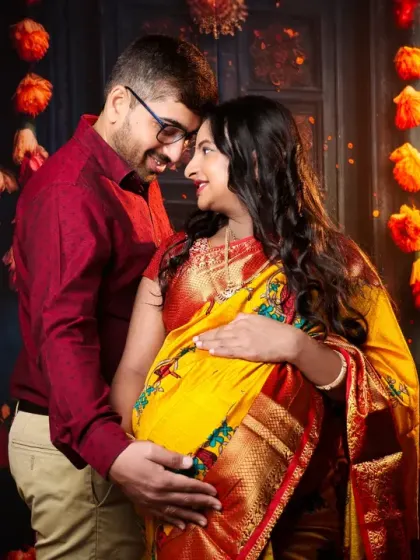 Capturing the warmth and love between partners during this special time. This festive setup with marigold garlands and soft lighting is perfect for celebrating your journey with a traditional touch.