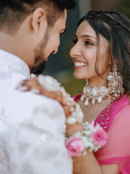 A close-up shot focusing on the bride's joyful expression as she looks at her partner. Capturing these loving glances is key to our candid photography style.