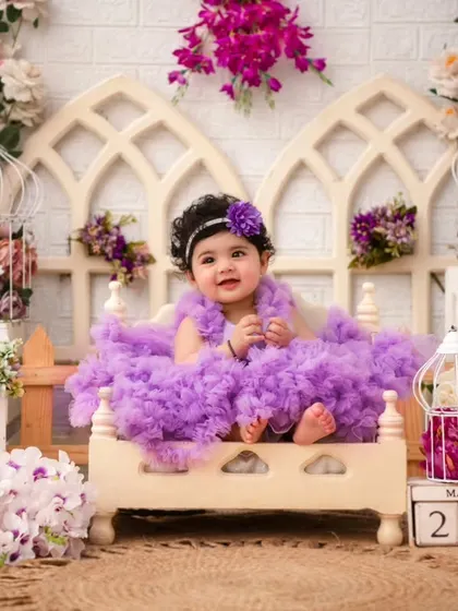 A beautiful portrait in a lavender-themed setup. The different shades of purple and pink create a rich and visually stunning backdrop.