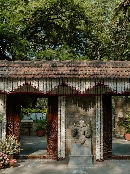 The entrance to the heritage venue, adorned with traditional floral garlands.