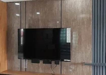 A completed TV unit from a recent project, featuring a combination of marble-finish panels and vertical fluting. This is another example of a beautiful, functional space successfully delivered to a happy client.