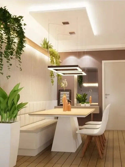 Another angle of the bench-style dining area, showing the modern pendant light and full-length mirror that makes the space feel larger.