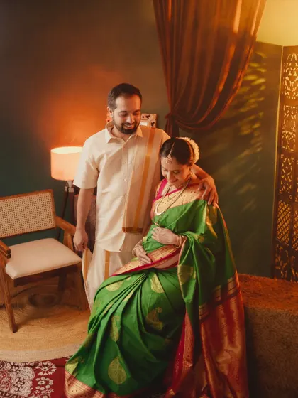 A warm and intimate couple portrait. The soft lighting and close framing create a sense of love and togetherness in this traditional maternity shoot.