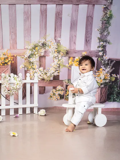 A happy sitter session in a beautiful garden-themed setup. This baby's joyful smile and ability to sit up on his own make this the perfect age to capture his budding personality.
