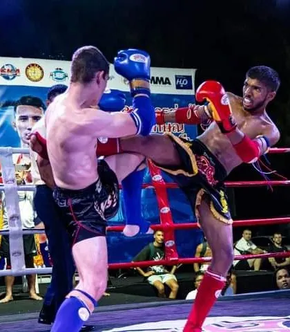 A powerful body kick being thrown in a competitive fight. We train our fighters to attack the entire body, breaking down their opponents.