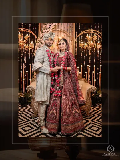 A classic full-length portrait of the couple on their wedding day. Their regal attire and the elegant backdrop create a timeless and sophisticated image.