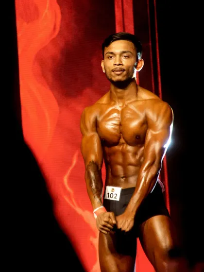 Hitting a front pose for the judges. Confidence and presentation are just as important as the physique itself, and we train for both.